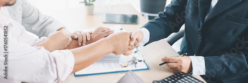 Panorama of successful real estate deal with handshake, contract, house key and calculator on desk, symbolizing mortgage loan approval, property investment, housing purchase and financial agreement.