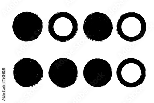 Different sizes and styles of black circles arranged in two rows on a plain background, illustrating various designs and shapes