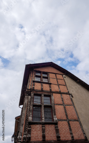 Ornate half-timbered medieval facade of a historic hunting lodge in the French Pyrenees