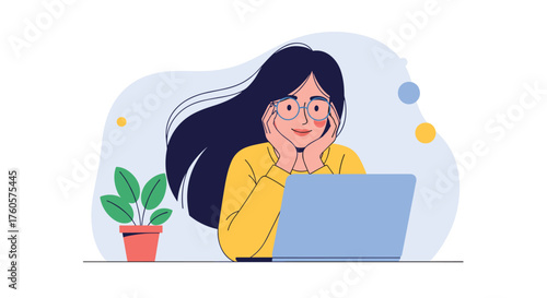 A young woman focused on her laptop at a desk.