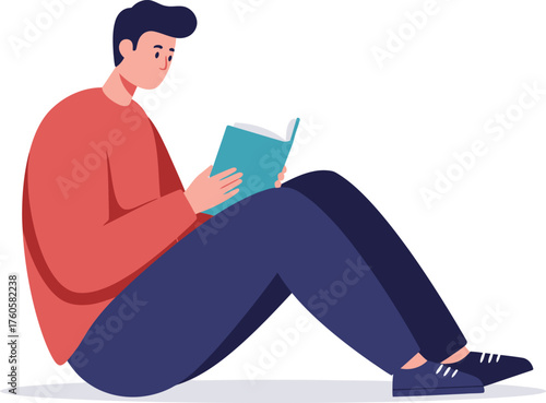Young man sitting comfortably on the floor engrossed in reading a book with a focused and relaxed expression on his face