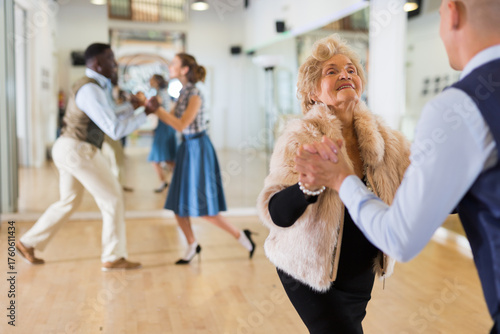 Tableau sur toile Mature woman learning to dance lindy hop with younger man