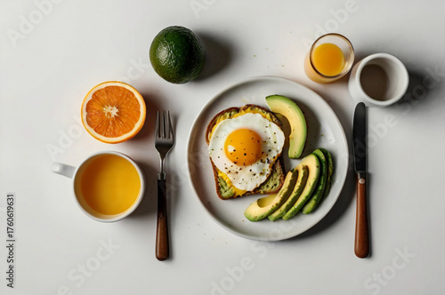 Overhead View of a Healthy Breakfast with Fried Egg, Avocado Toast, and Orange Juice