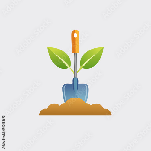 Gardening shovel with green leaves growing in the soil.