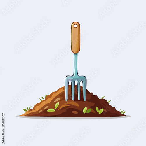 Garden Fork in a Pile of Rich Brown Soil with Green Sprouts.