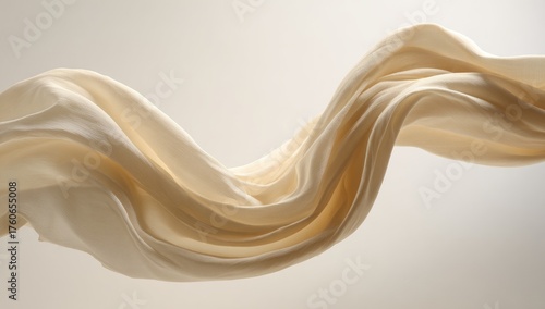 Cream-colored fabric drapes in flowing curves