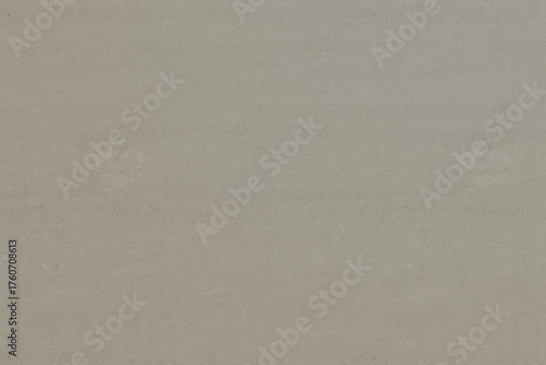 A subtle, light taupe surface features faint horizontal striations and scattered, barely visible, symmetrical textural imperfections, creating a minimalist background