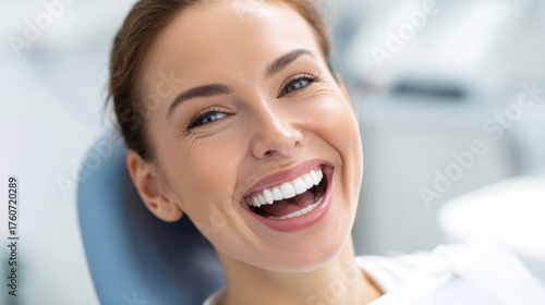 Free Download A cheerful woman smiles widely while sitting comfortably in a clean dental office ready for her appointment. - GFXLoad