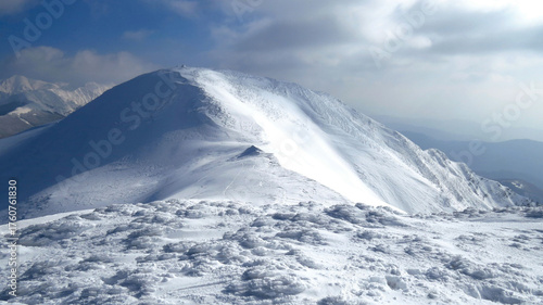 The summit and ridge of Mount Bocco covered in fresh snow on a sunny winter day, Parma Apennines.