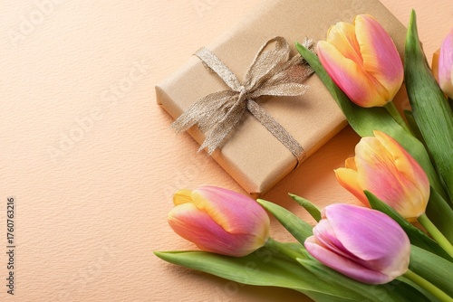 Fresh Tulips Next to a Beautifully Wrapped Gift on a Soft Pastel Background