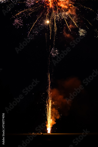 Golden Firework Launch With Spark Trail Against Night Sky - Vertical Format