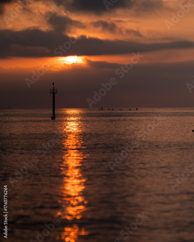 Beautiful sunset over the Mediterranean Sea in Barcelona, Spain. Golden sunlight reflects on gentle ocean waves, creating a peaceful and romantic atmosphere. Perfect for travel, nature, and landscape 