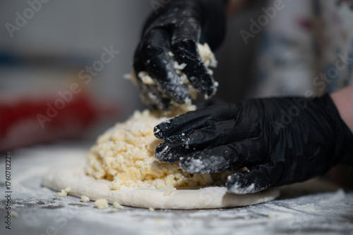 Hands Preparing Dough with Cheese Filling