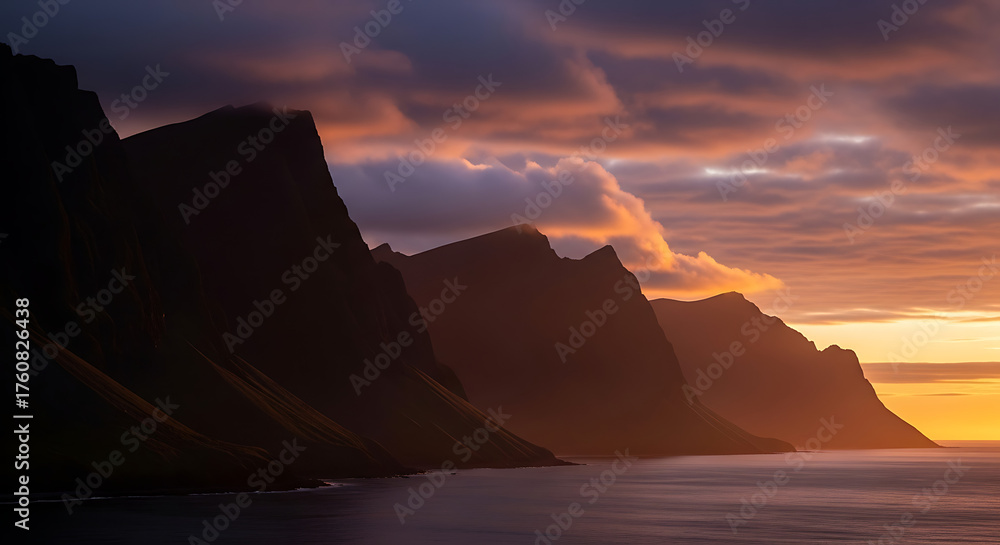 Naklejka premium Dramatic Sunset Silhouette of Coastal Cliffs Over the Ocean
