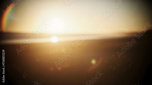 Ethereal golden light overlay with vintage film dust and rainbow lens flare.