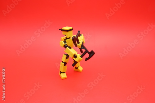 Yellow Action Figure Holding Dual Axes on Red Background