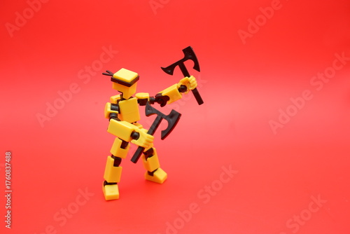 Yellow Action Figure Holding Dual Axes on Red Background