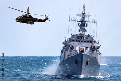 A helicopter flies near  warship during a naval exercise in the Black Sea. 