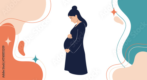 A pregnant woman in a dark dress holding her belly.
