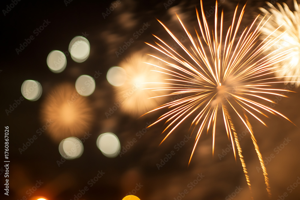 Fototapeta premium Spectacular fireworks display illuminates the night sky with brilliant golden bursts, creating a mesmerizing visual spectacle. Celebration moments in time captured!