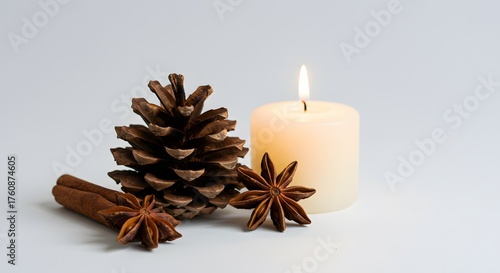 Close-up of Aromatic Spices and Pine Cone with a Lit Candle on a Light Background