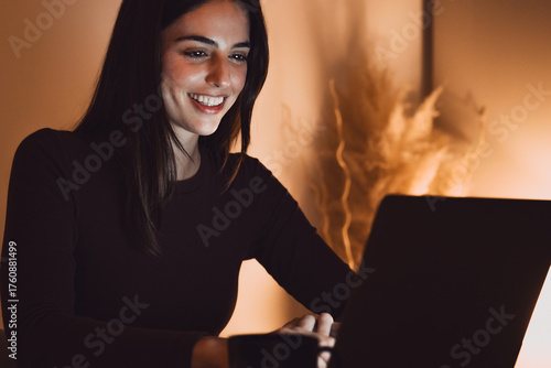 Photography Head shot pleasant happy young woman freelancer working on computer at night