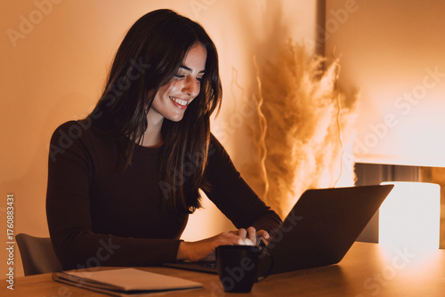 Canvas Print Head shot pleasant happy young woman freelancer working on computer at night