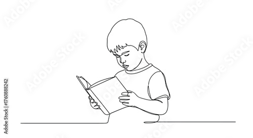 A young boy intently reads a book with a focused expression.