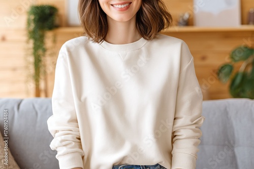 Woman in cream-colored long-sleeved crewneck sweatshirt and jeans