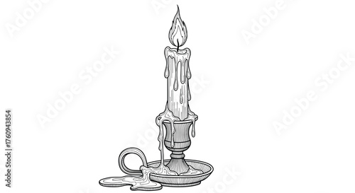 A lit candle in a holder with a loop attached to the base.