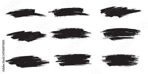 Set of nine textured black grunge brush strokes hand-painted ink swipes with rough edges.