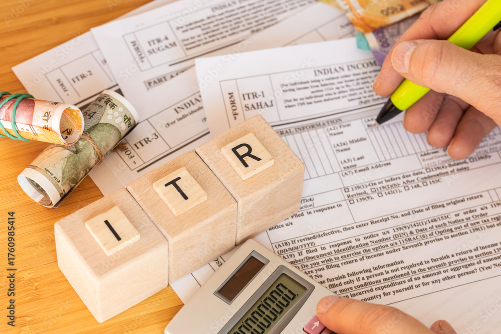Obraz premium India taxes. Various ITR forms to fill out. Income tax return. Annual tax declaration. Financial concept. ITR written on wooden blocks. Close up