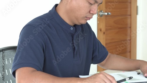 Young asian businessman is suffering pain on wrist, finger and arm, arthritis inflammation while working and he is massaging himself and doing exercise with his hands to relax and to relieve pain.	
