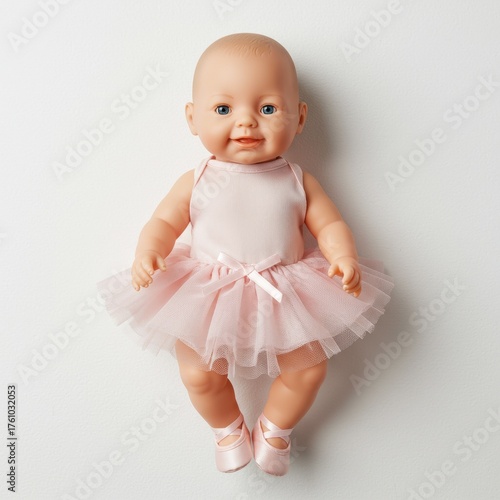 Baby doll in pink tutu dancing with raised arm on white