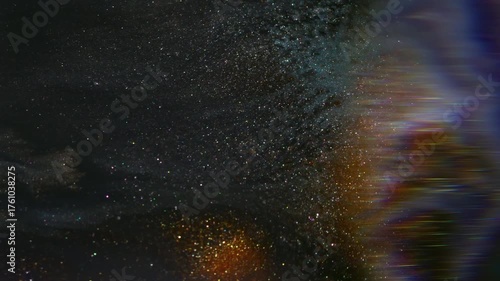 Shiny shimmer ink. Blur marble texture. Defocused purple golden multicolor acrylic pigment flowing on abstract dark black background.