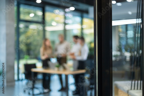 Businessmen blur in the workplace in office with computer or shallow depth of focus of abstract background, view from glass wall