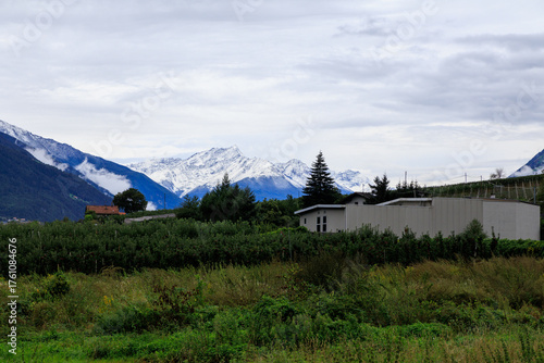 Mountain panorama with snowcapped mountains and summit Laaser Spitze (Orgelspitze) in Ortler Alps and valley Etschtal on a cloudy day in autumn in South Tyrol, Italy