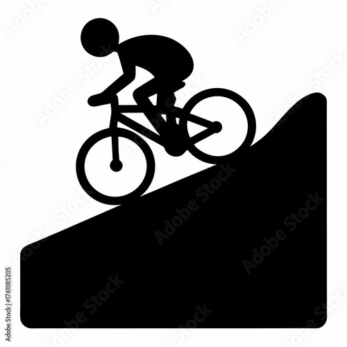 Silhouette of a cyclist riding down a steep hill or mountain