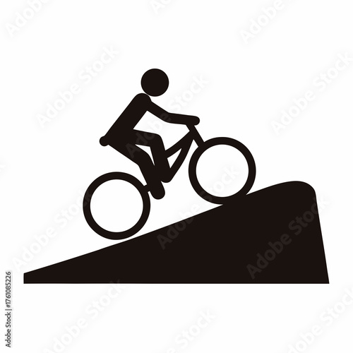 Silhouette image of a person riding a bicycle uphill on a ramp
