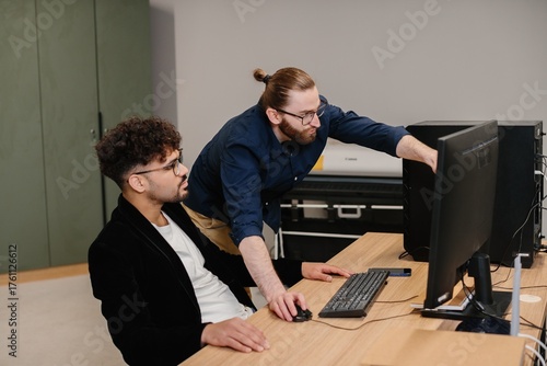 Diverse business professionals collaborating on computer it support