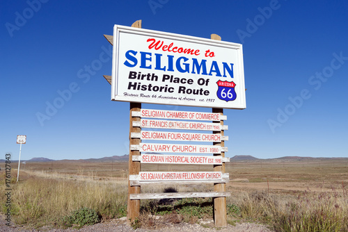 Welcome and information sign in Seligman, Arizona, USA, October 2025. The roadside marker greets visitors to the historic Route 66 town, set against a clear desert sky.