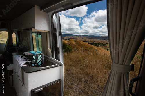 Camper Van View of Remote, Dry Hills During Road Trip Adventure