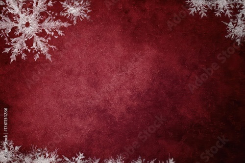 Elegant dark red textured background with delicate white snowflakes adorning the corners for a festive winter holiday design