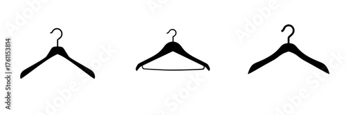 Different styles of clothing hangers arranged in a row against a white background during daylight hours