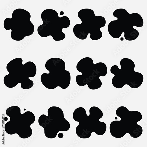 Abstract organic shapes, blobs, splatters, and blots in black, isolated on a white background, representing fluidity and amorphous forms