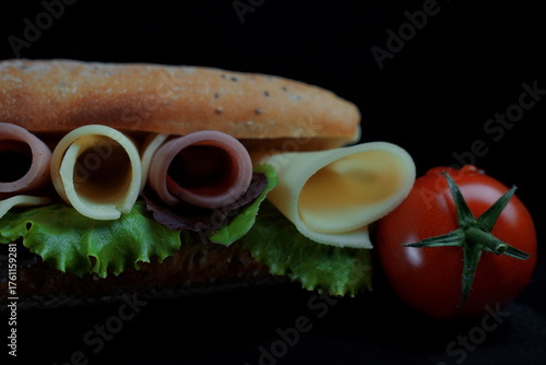 Fototapeta Naklejka Na Ścianę i Meble -  Sandwich with fresh bread cheese ham and lettuce 