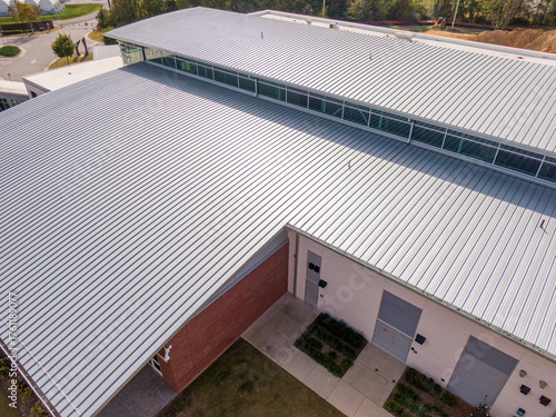 Sunny Daytime Drone Images of a New Commercial Building With A Large Standing Seam Metal Roofing System