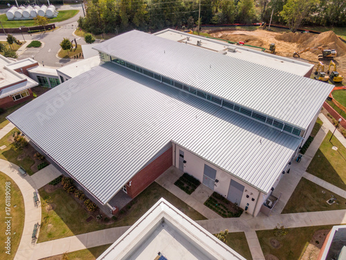 Sunny Daytime Drone Images of a New Commercial Building With A Large Standing Seam Metal Roofing System: Architecture, Roofing, Industry