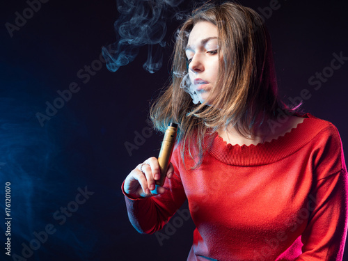 Woman vaper in red blouse. ...