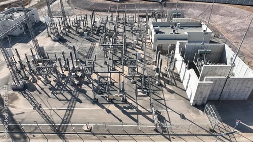 Electric power station and urban energy hub supplying electricity to the city. Industrial infrastructure and energy network under bright daylight.